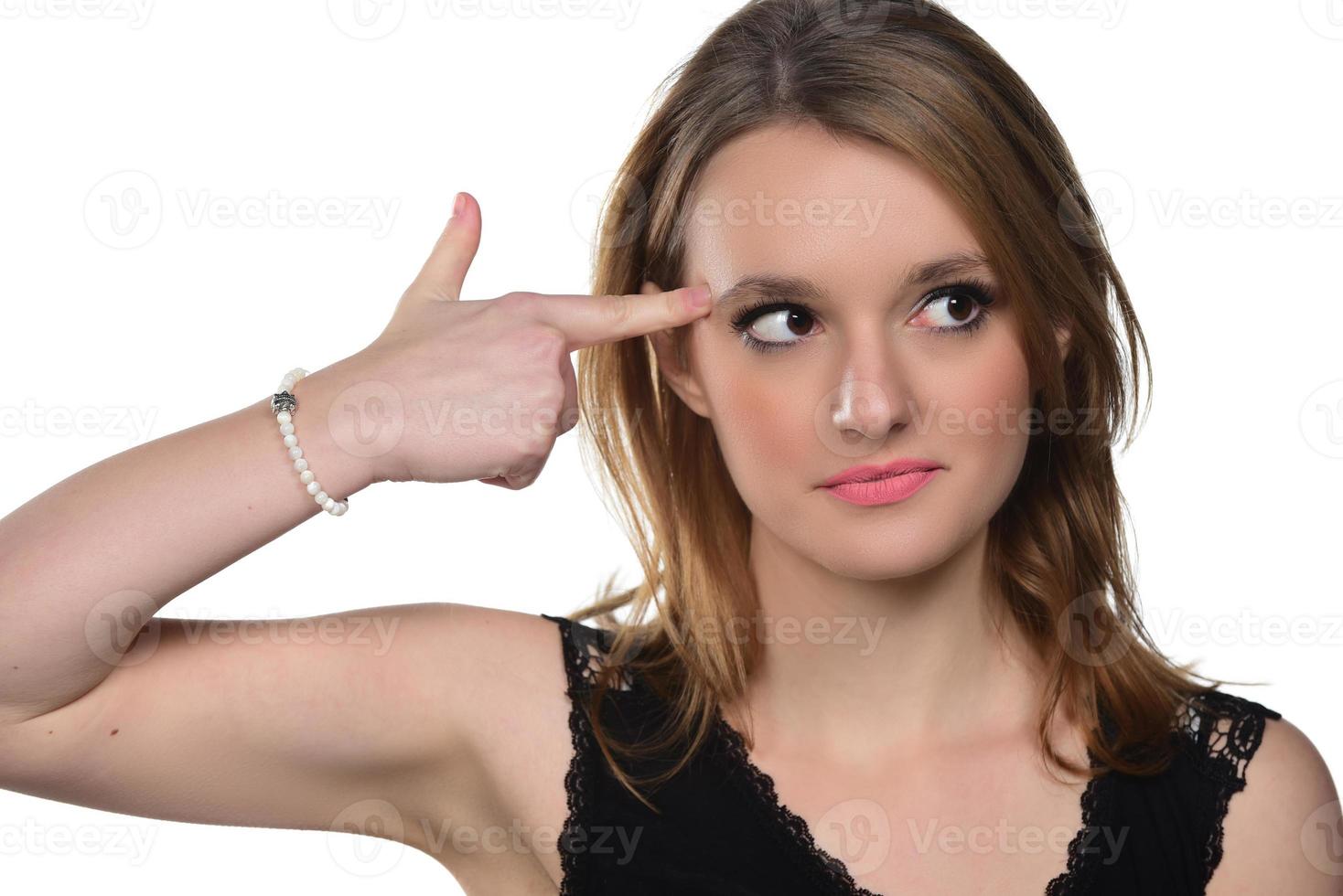 Portrait of young beautiful woman peeping at the camera making funny face and showing loser sign. isolated on white photo