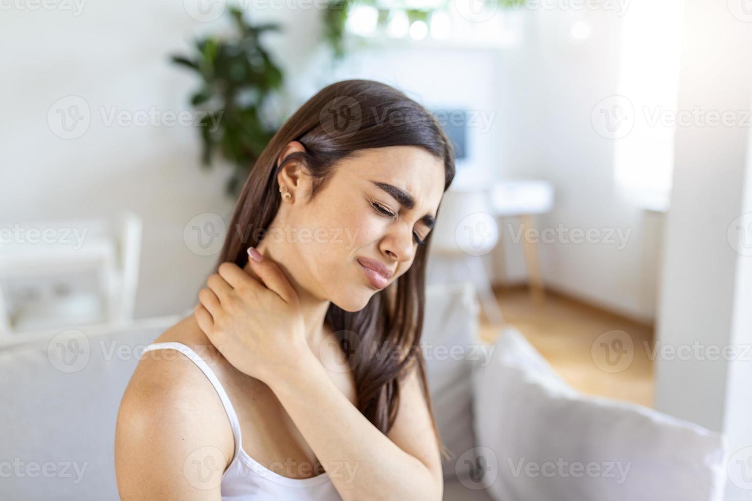 Tired woman massaging stiff sore neck, tensed muscles fatigued from computer work in incorrect posture while feeling hurt joint shoulder back pain ache. Fibromyalgia concept photo