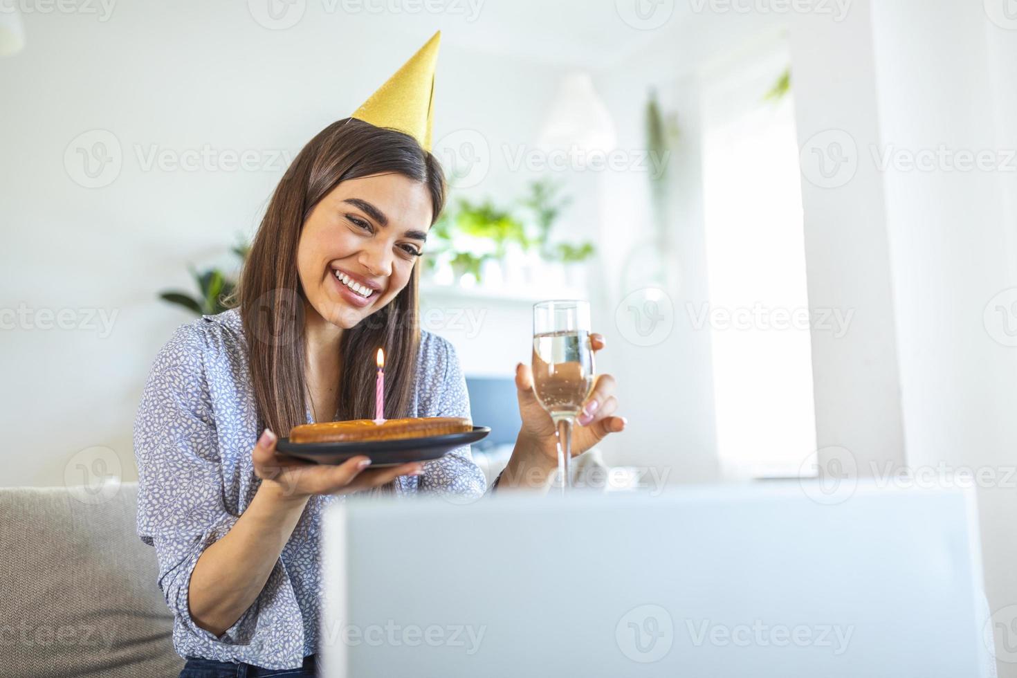 New normal concept. Happy woman celebrating her birthday alone. young woman holding a cake. Birthday party at home. Family video call. Social distancing. Life at home. photo