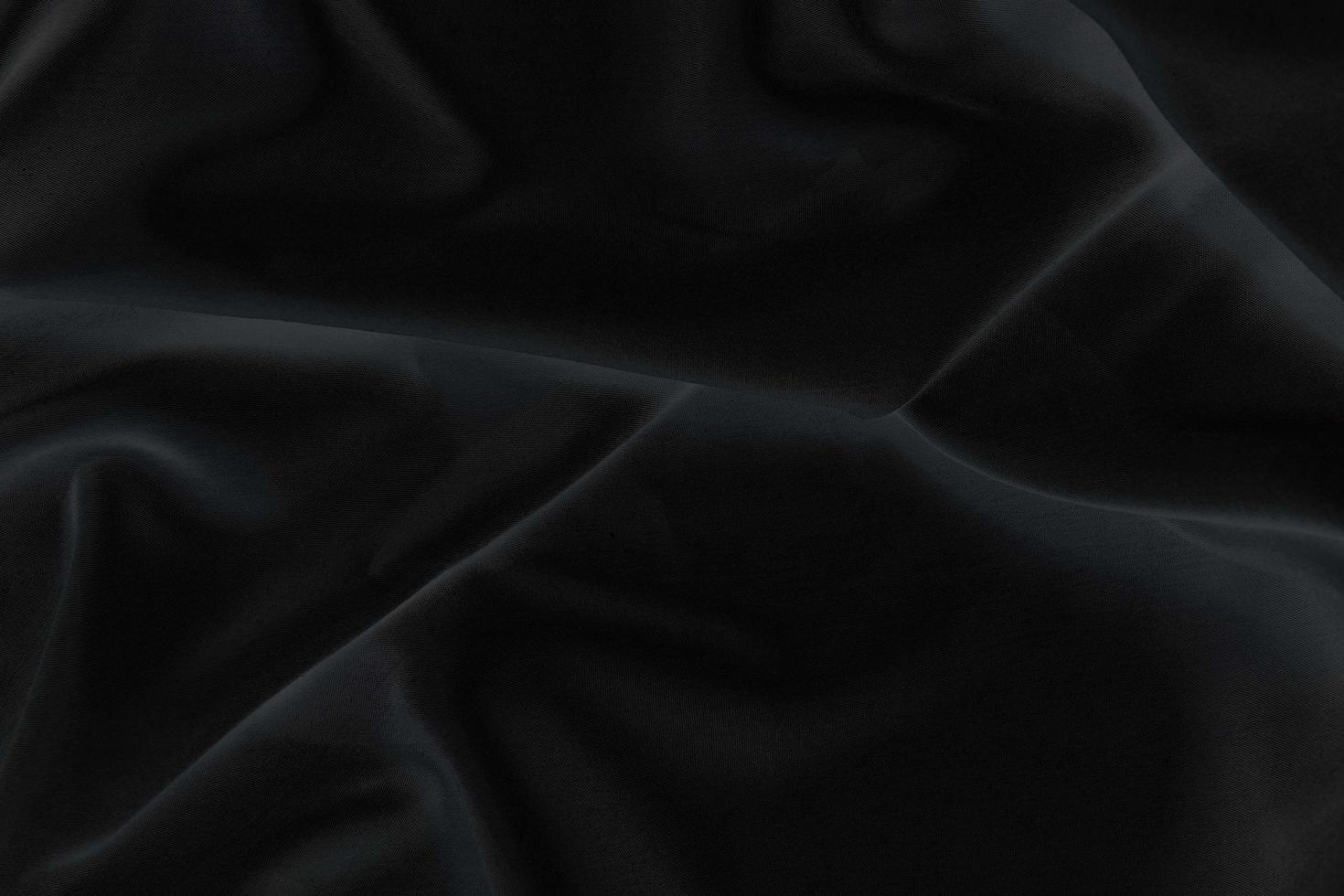 Smooth elegant black silk fabric or satin luxury cloth texture for abstract background photo