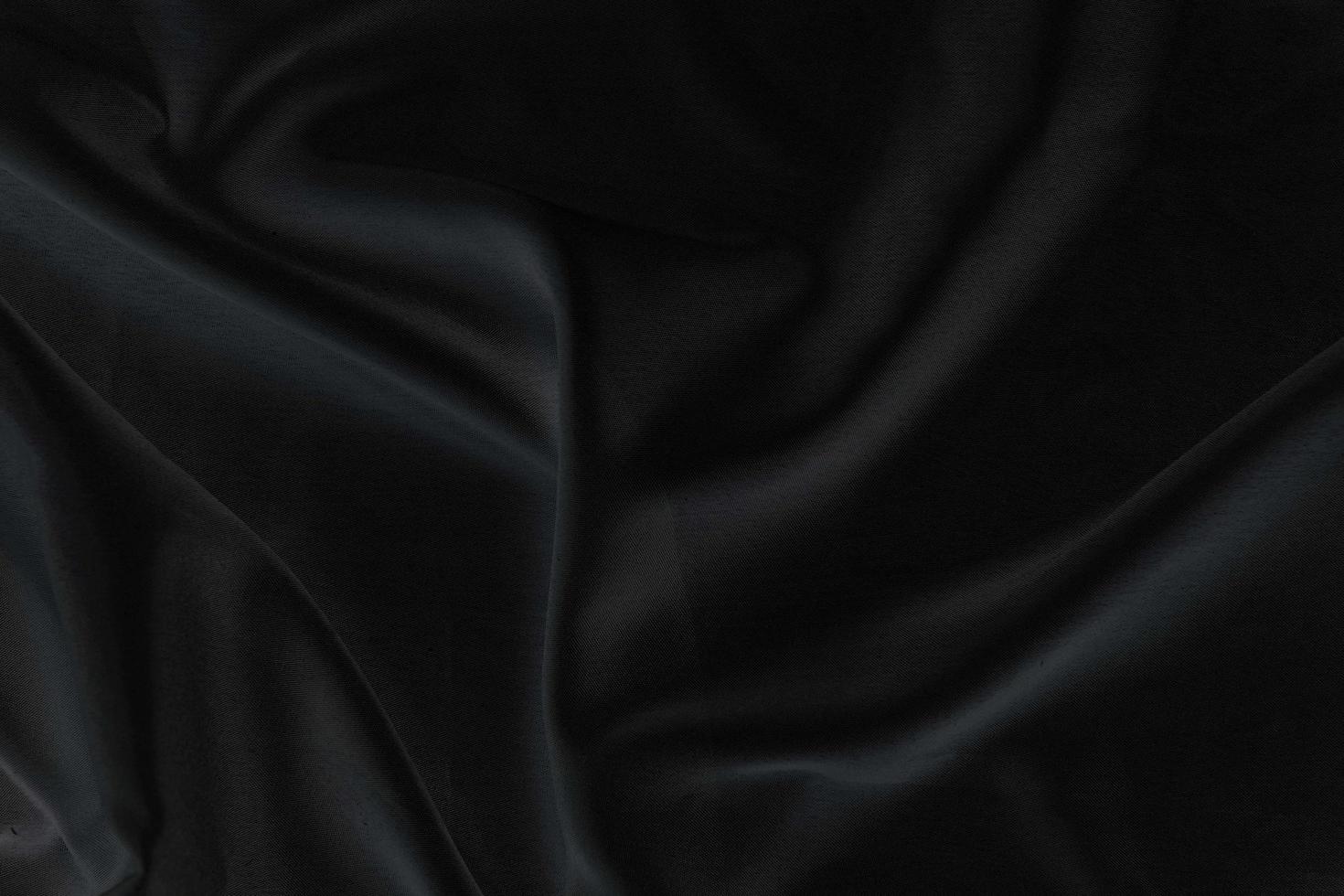 Smooth elegant black silk fabric or satin luxury cloth texture for abstract background photo