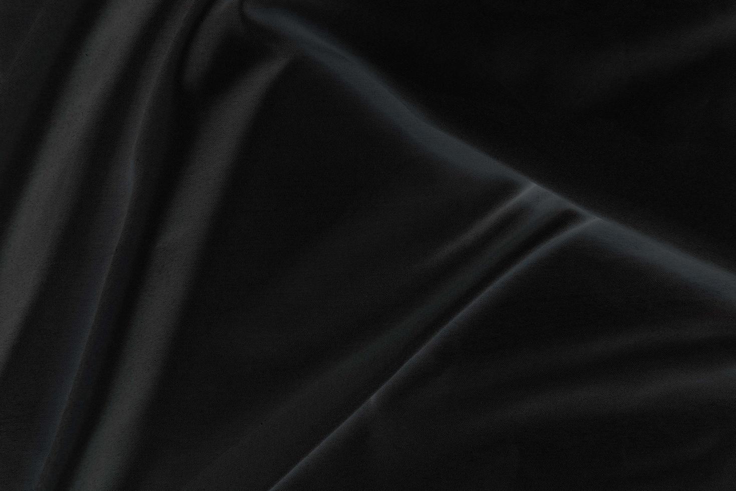 Smooth elegant black silk fabric or satin luxury cloth texture for abstract background photo
