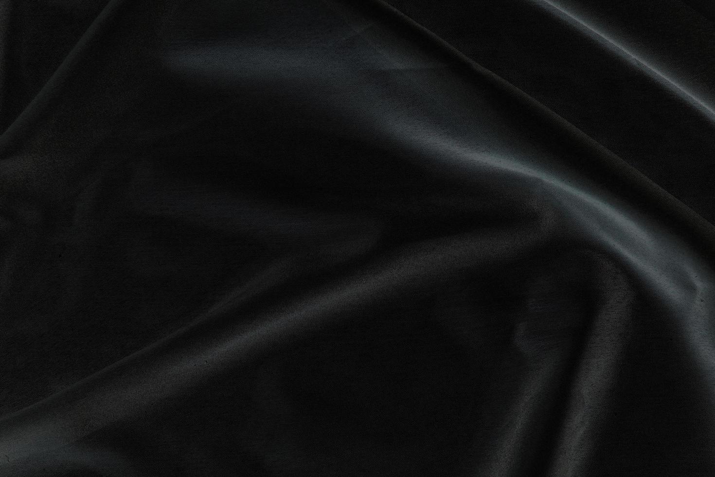 Smooth elegant black silk fabric or satin luxury cloth texture for abstract background photo