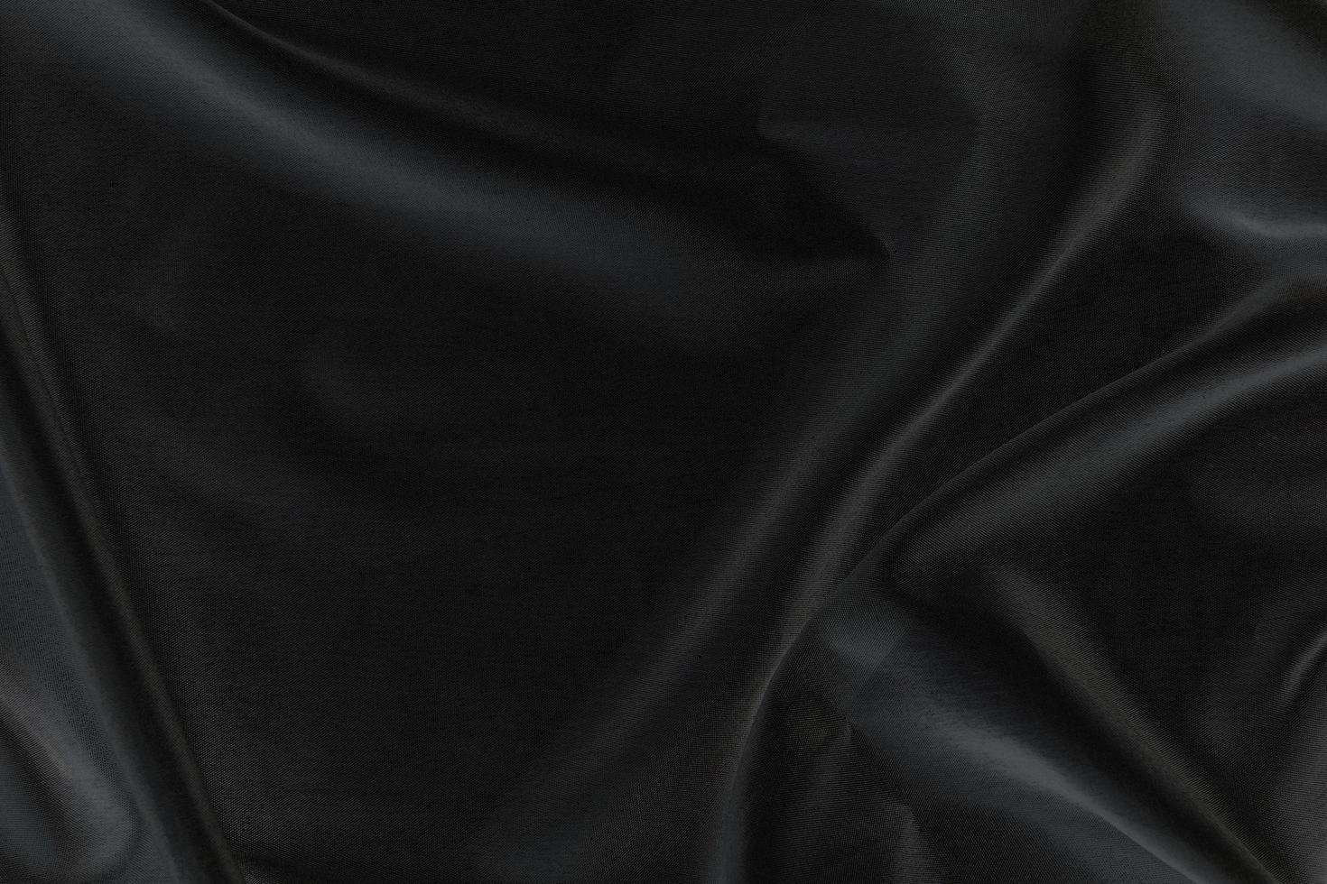 Smooth elegant black silk fabric or satin luxury cloth texture for abstract background photo