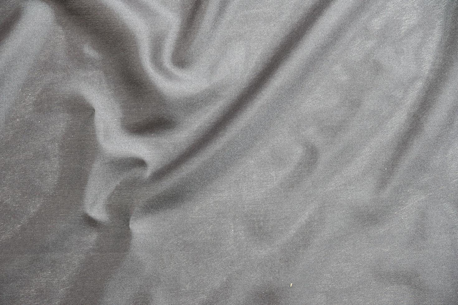 Smooth elegant black silk fabric or satin luxury cloth texture for abstract background photo