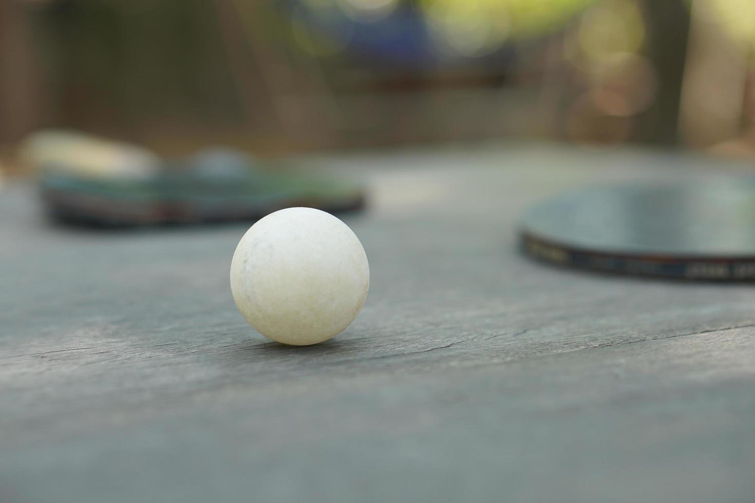 Table tennis loops and racket on wooden table photo