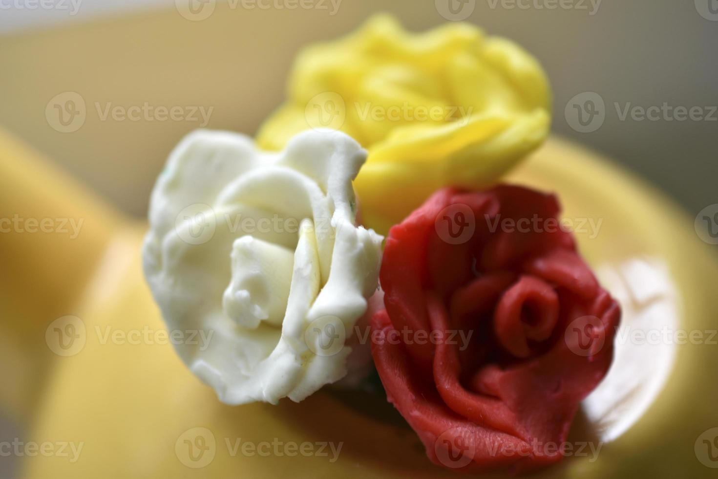 Yellow decorative teapot on the windowsill. Teapot with decorative flowers. photo