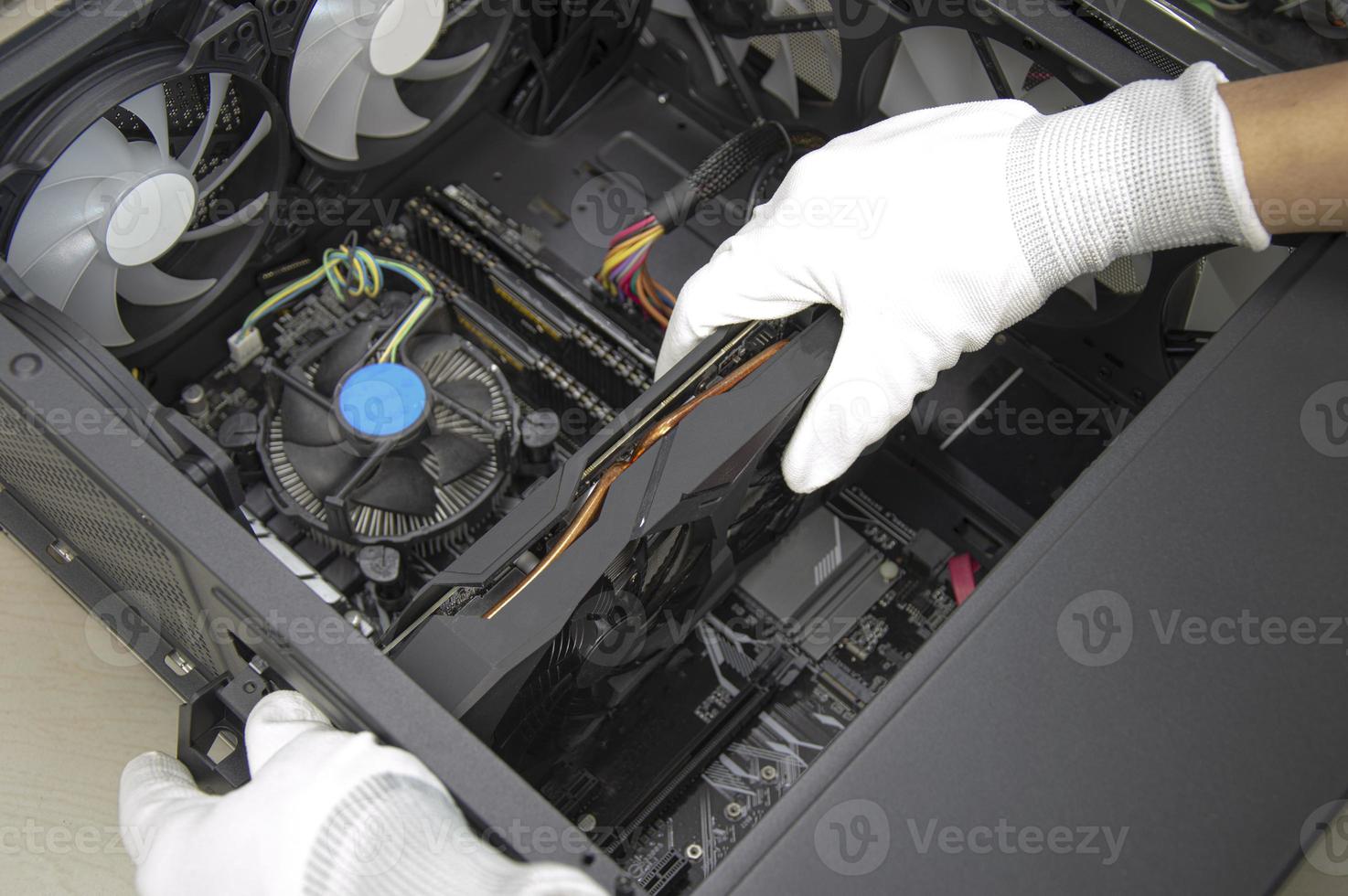 top view mechanic installing graphics card photo