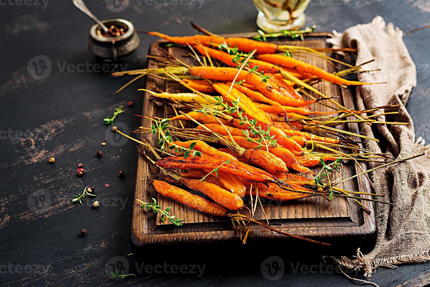 Baked organic carrots with thyme, honey and lemon. Organic vegan food. photo