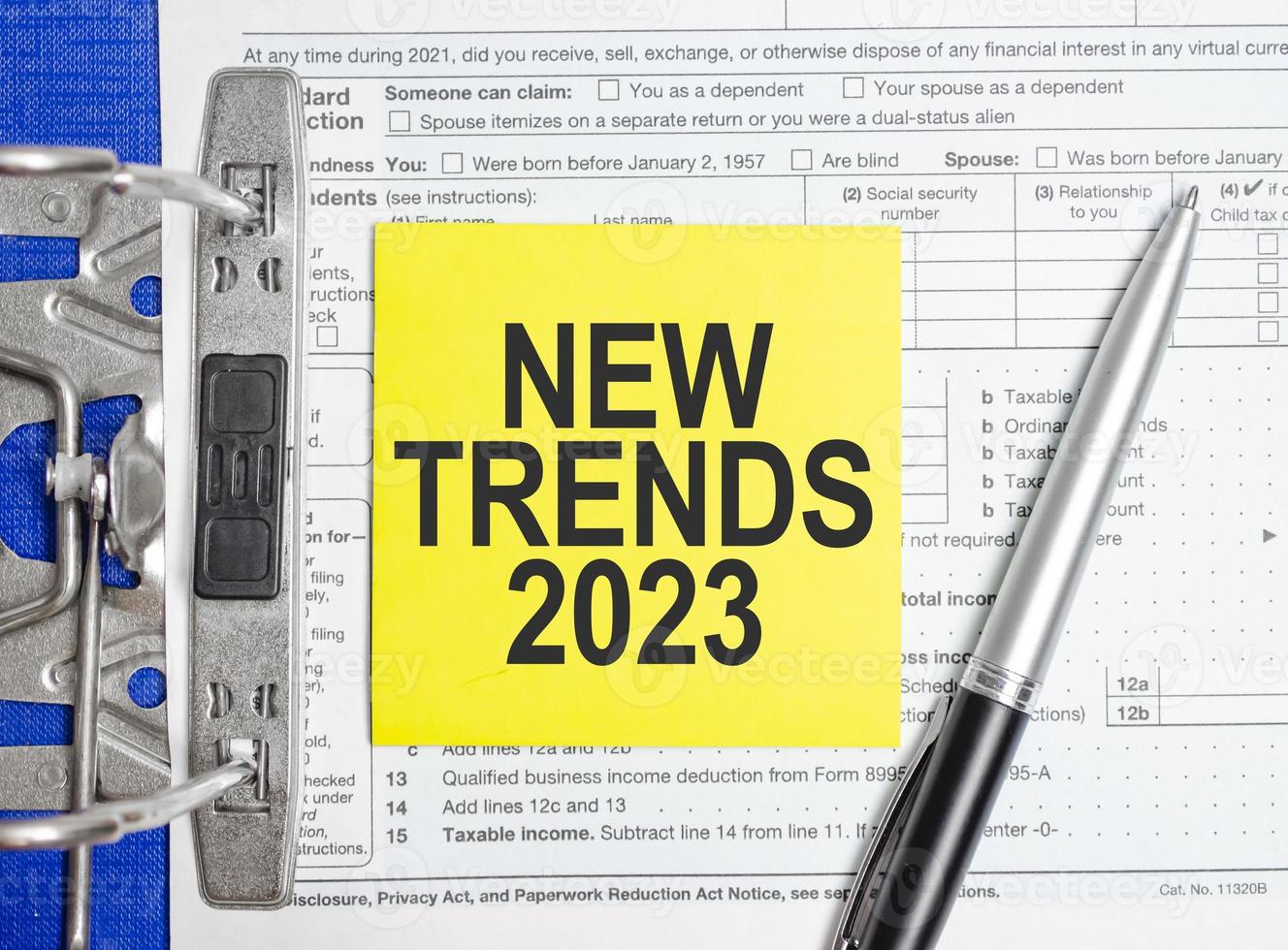 TRENDS 2023 words on paper notebook with pen photo