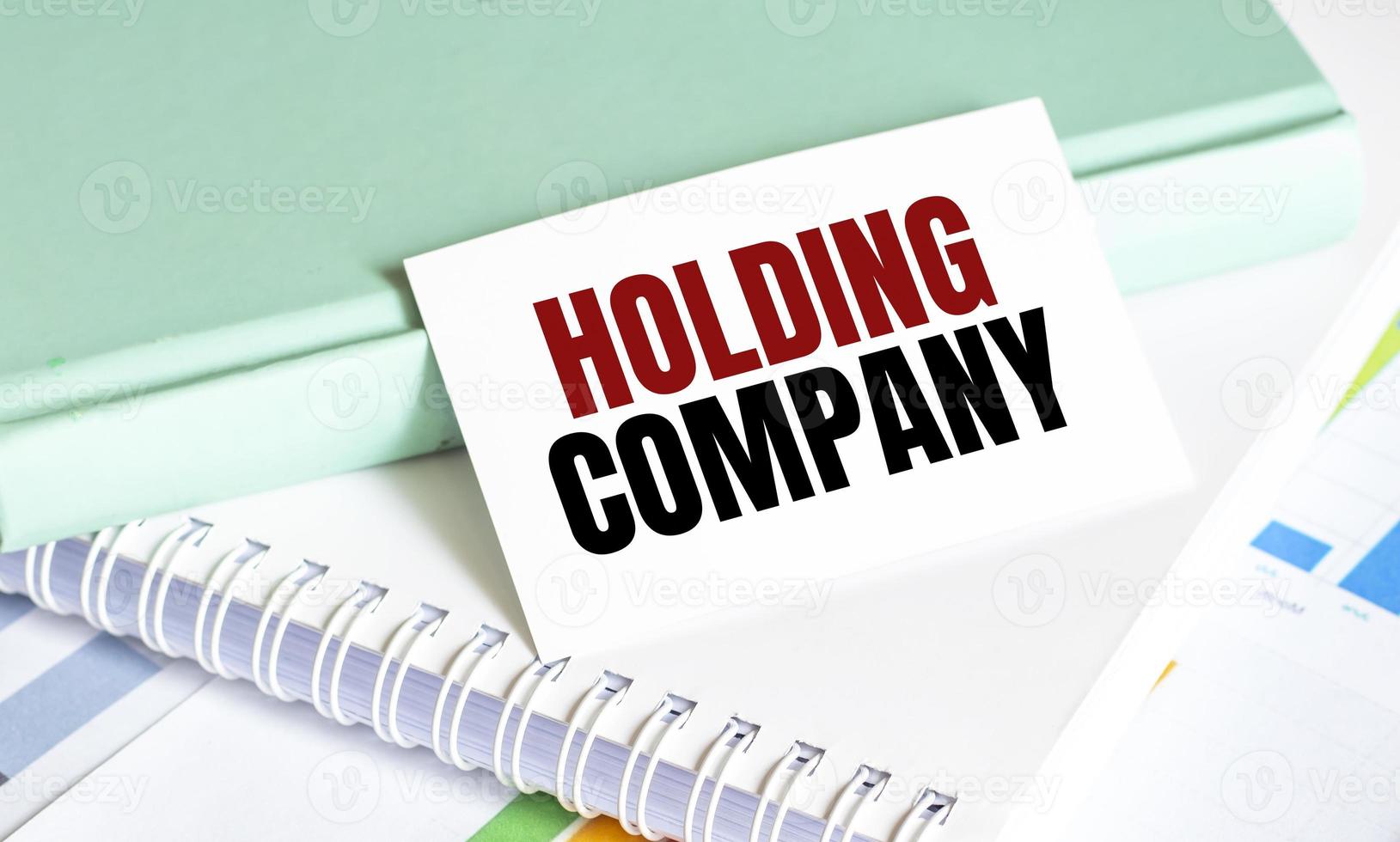 holding company words on business card and charts photo