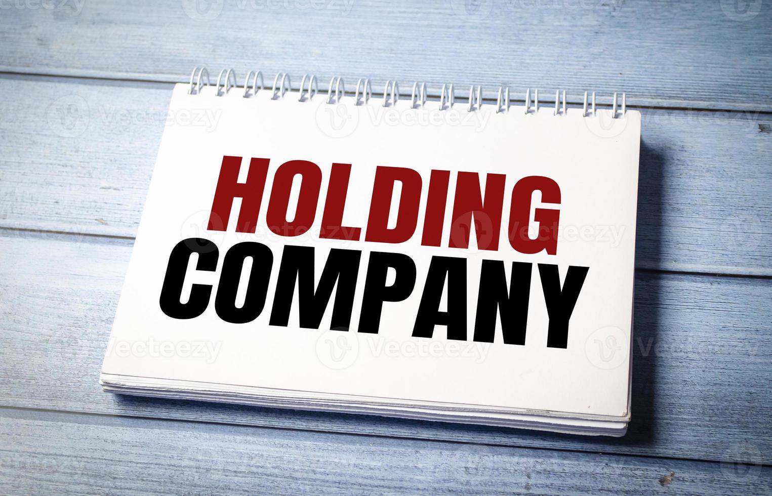 holding company words with calculator and charts photo