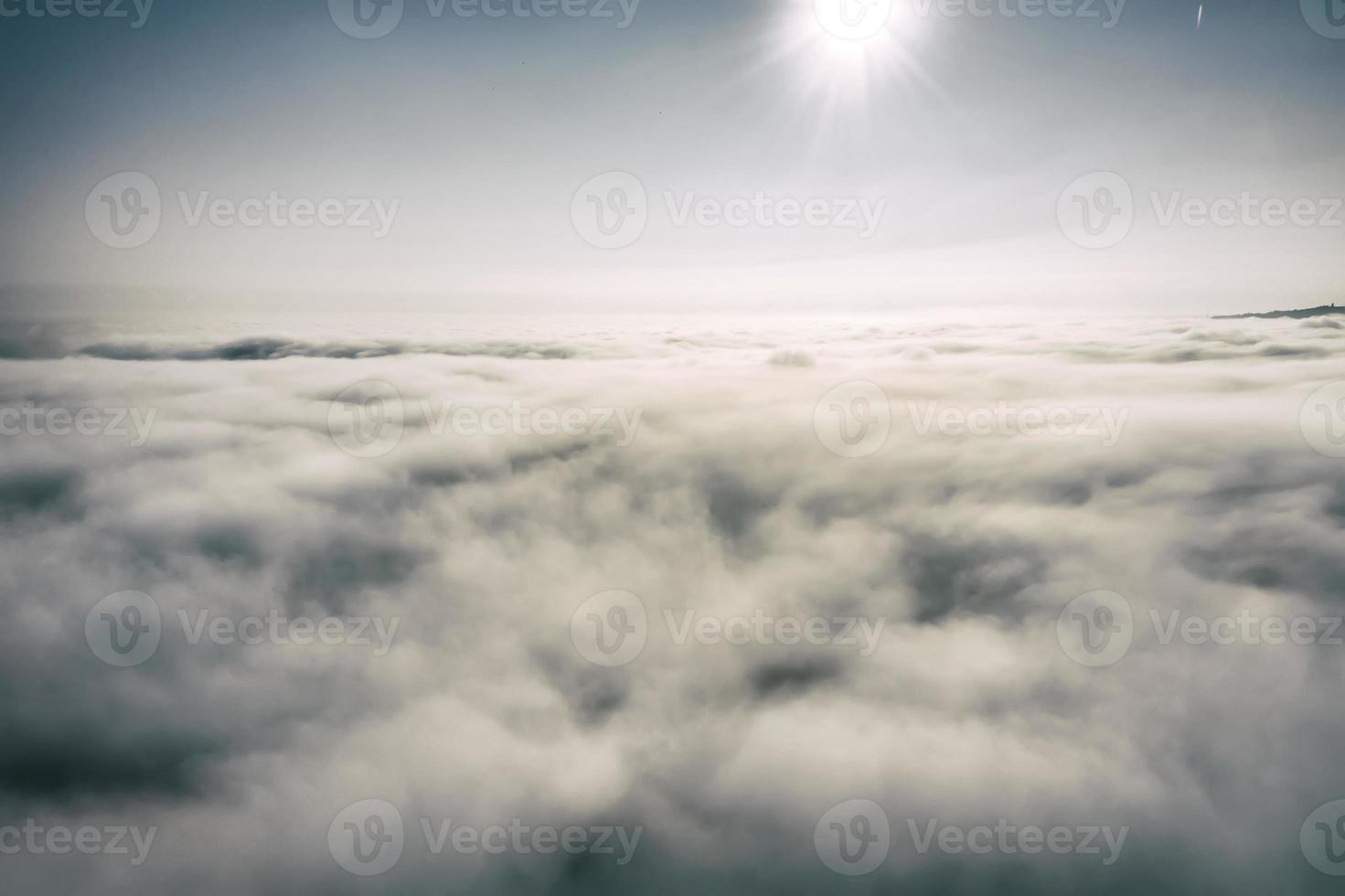 Aerial view white clouds in a blue sky. View from drone. Aerial bird's eye view. The texture of the clouds. View from above. Sunrise or sunset over clouds. photo