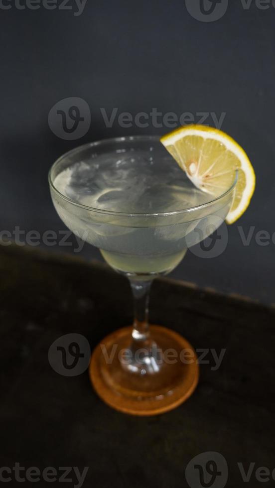 Lemonade. refreshing sparkling drink in an elegant glass garnished with a lemon wedge photo