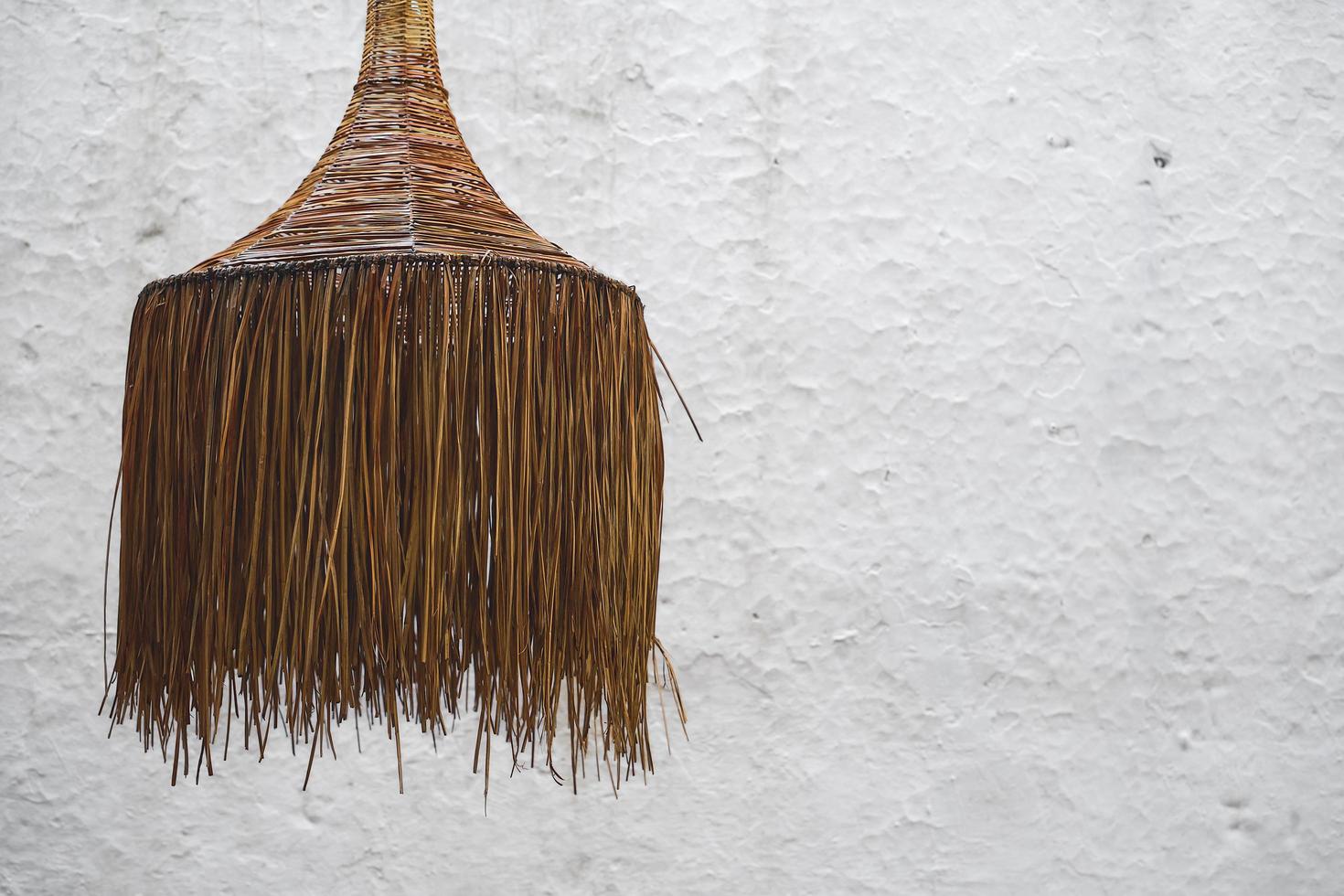 Wicker chandelier in a cafe on the background of a white wall interior design idea, selective focus on the chandelier, style photo