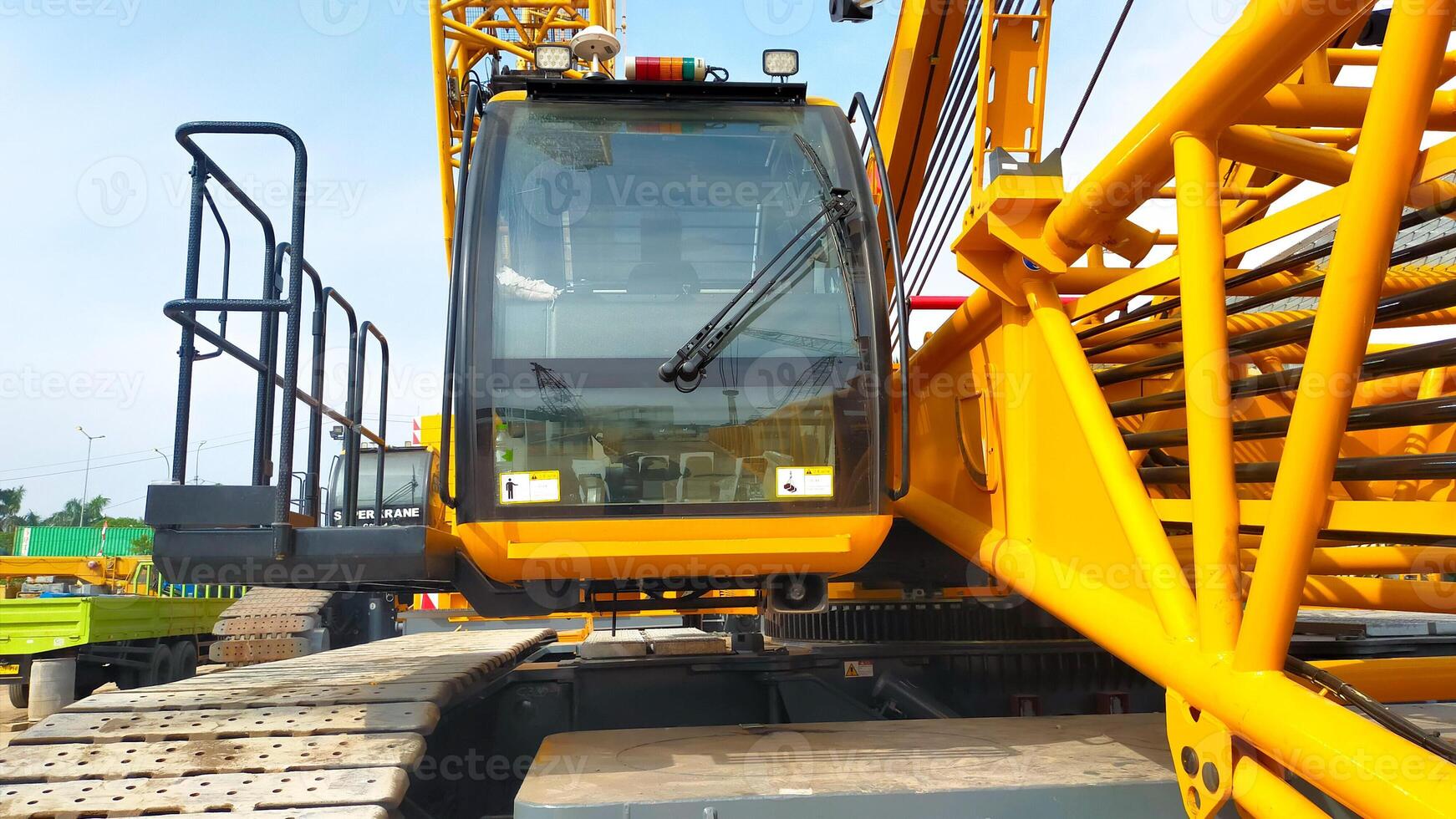Large yellow crawler crane operator cabin front look. photo