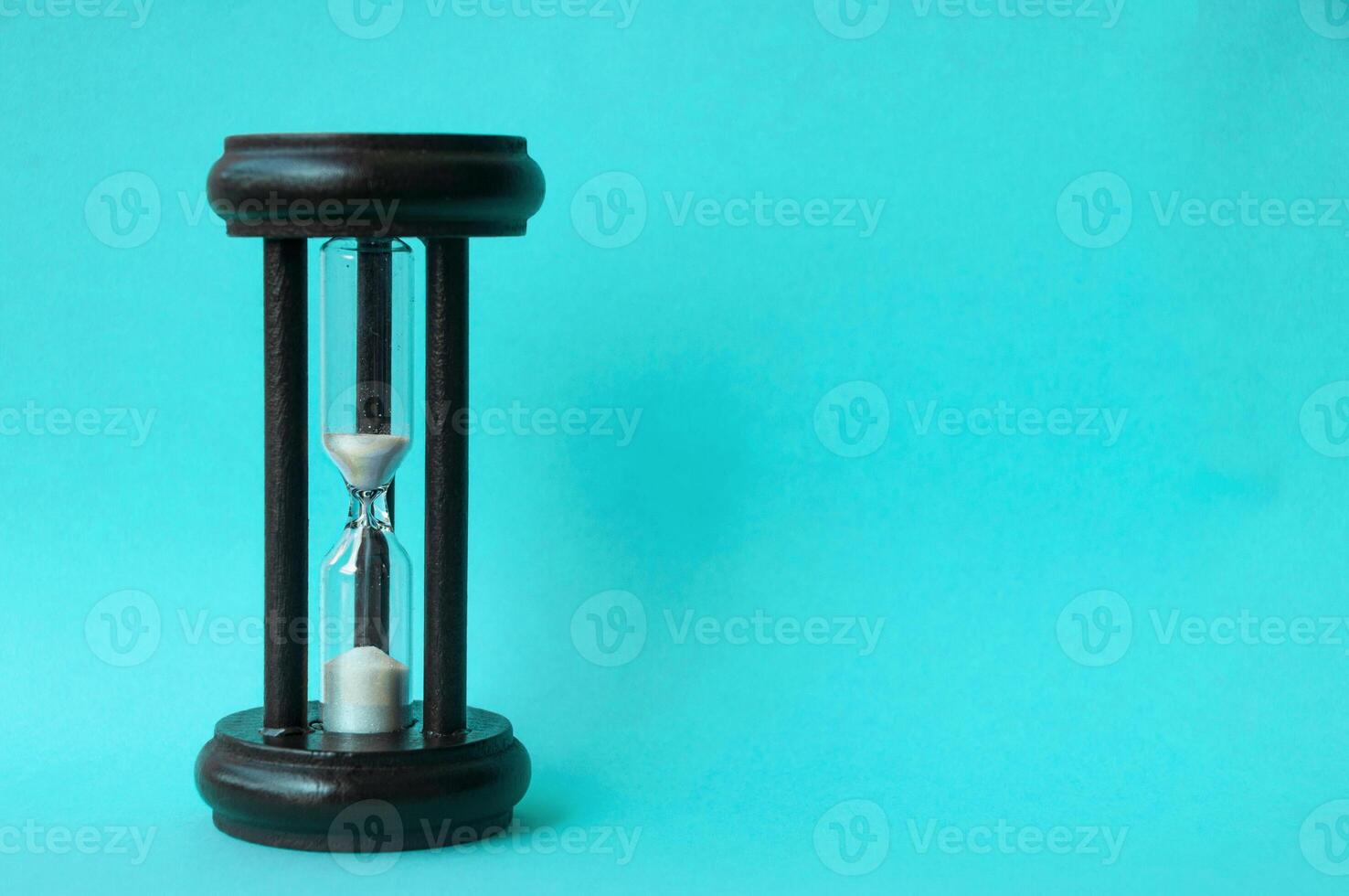 Minute glass isolated on light blue background. Copy space concept