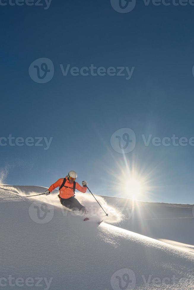 Skier on a sunny day of fresh snow photo