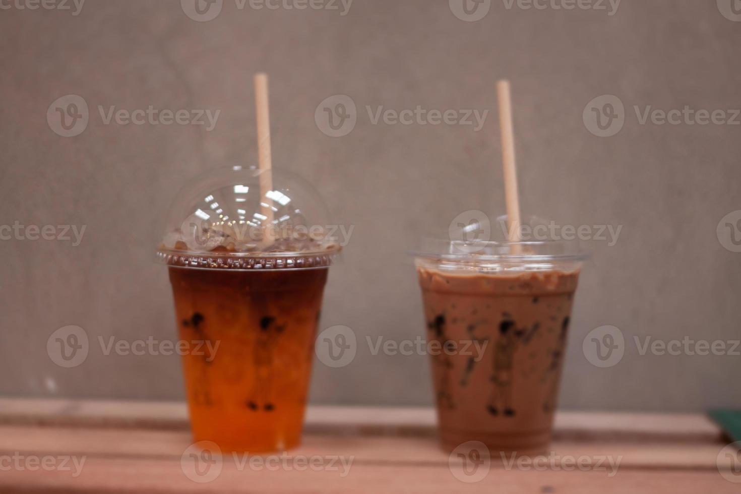 Black coffee with orange juice and iced mocha on wooden table photo