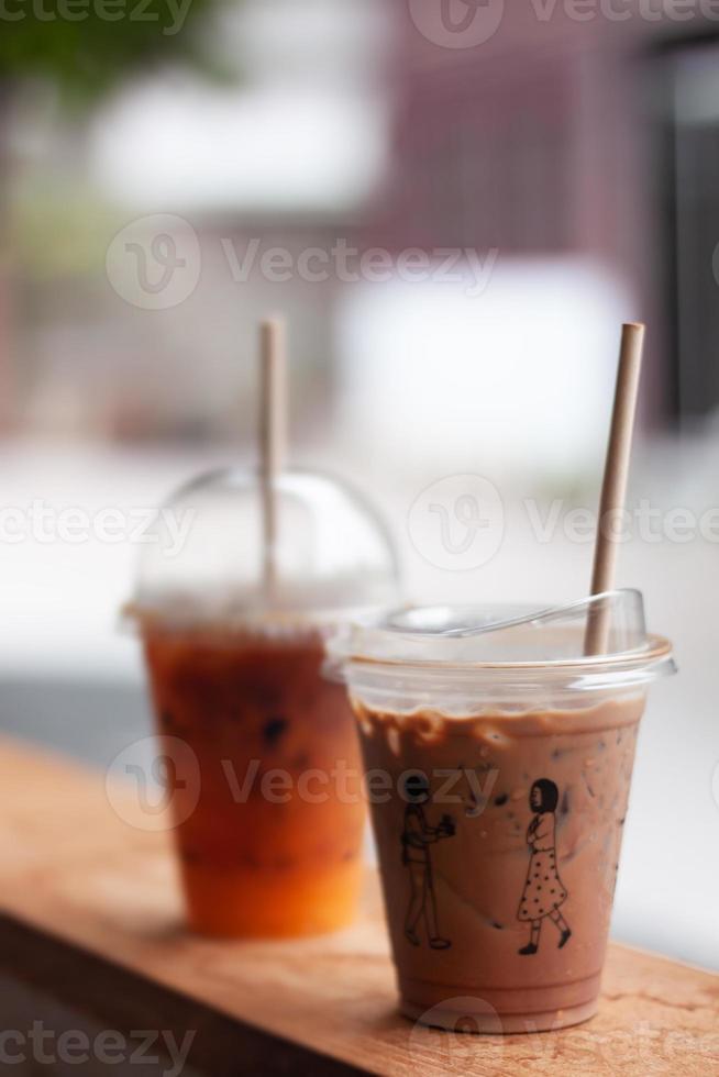 Black coffee with orange juice and iced mocha on wooden table photo