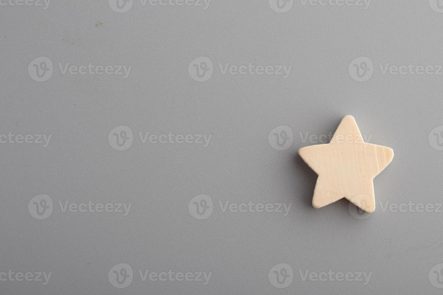 Five wooden stars on gray background.Copy space. photo