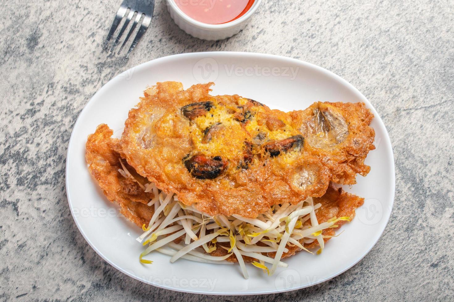 Fried mussels in crispy batter in a white plate photo