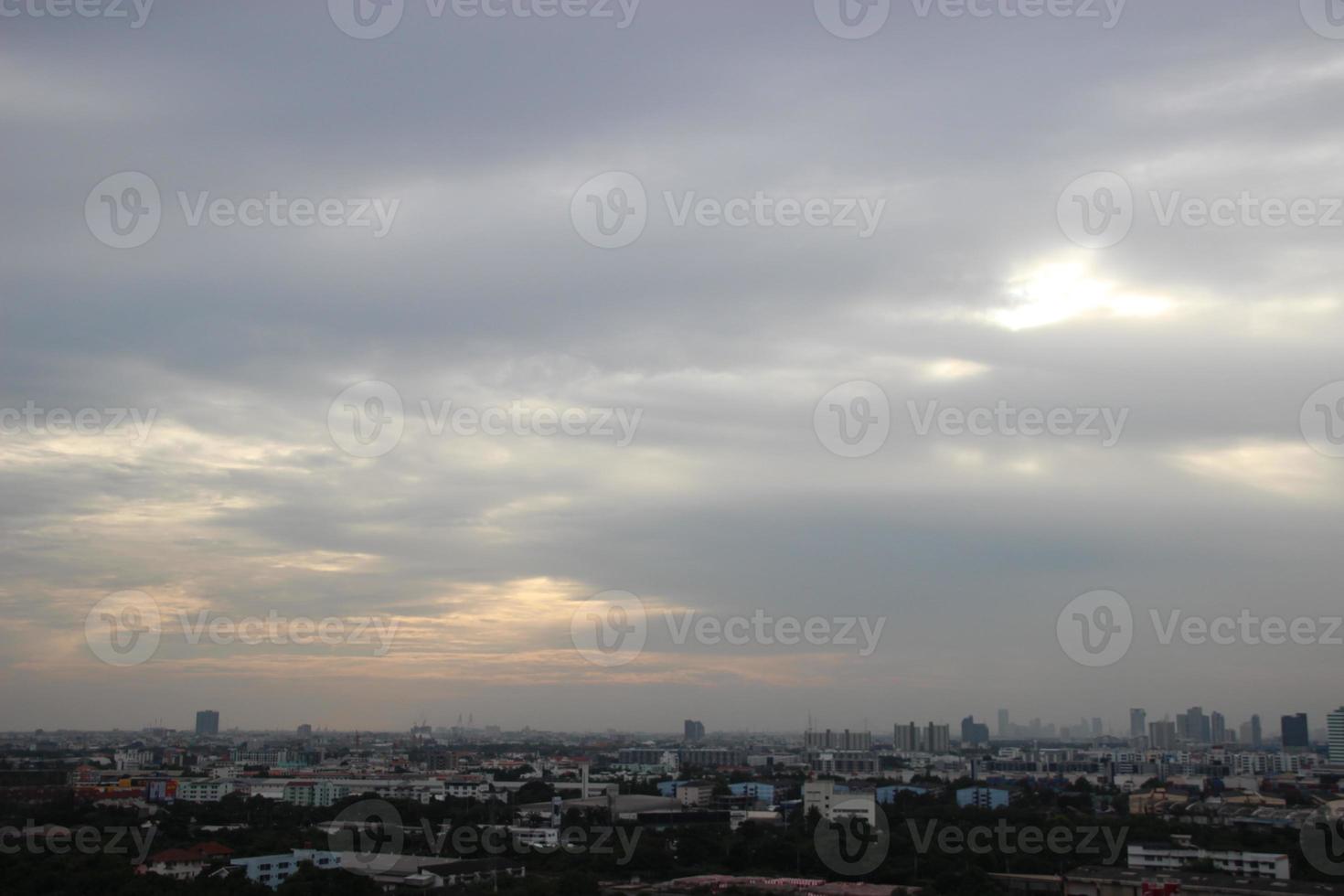 dark storm cloudy sky in rainy day with city building background photo