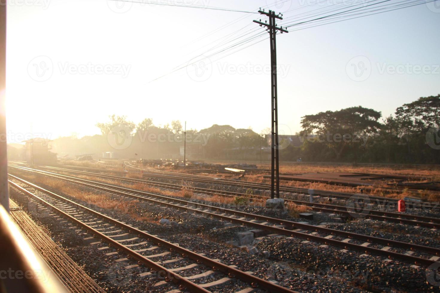 outside window railroad tracks in the countryside with sunset sky photo