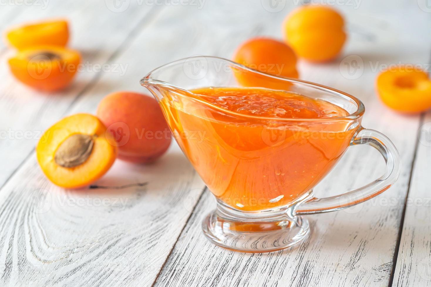 Glass vase of apricot jam photo