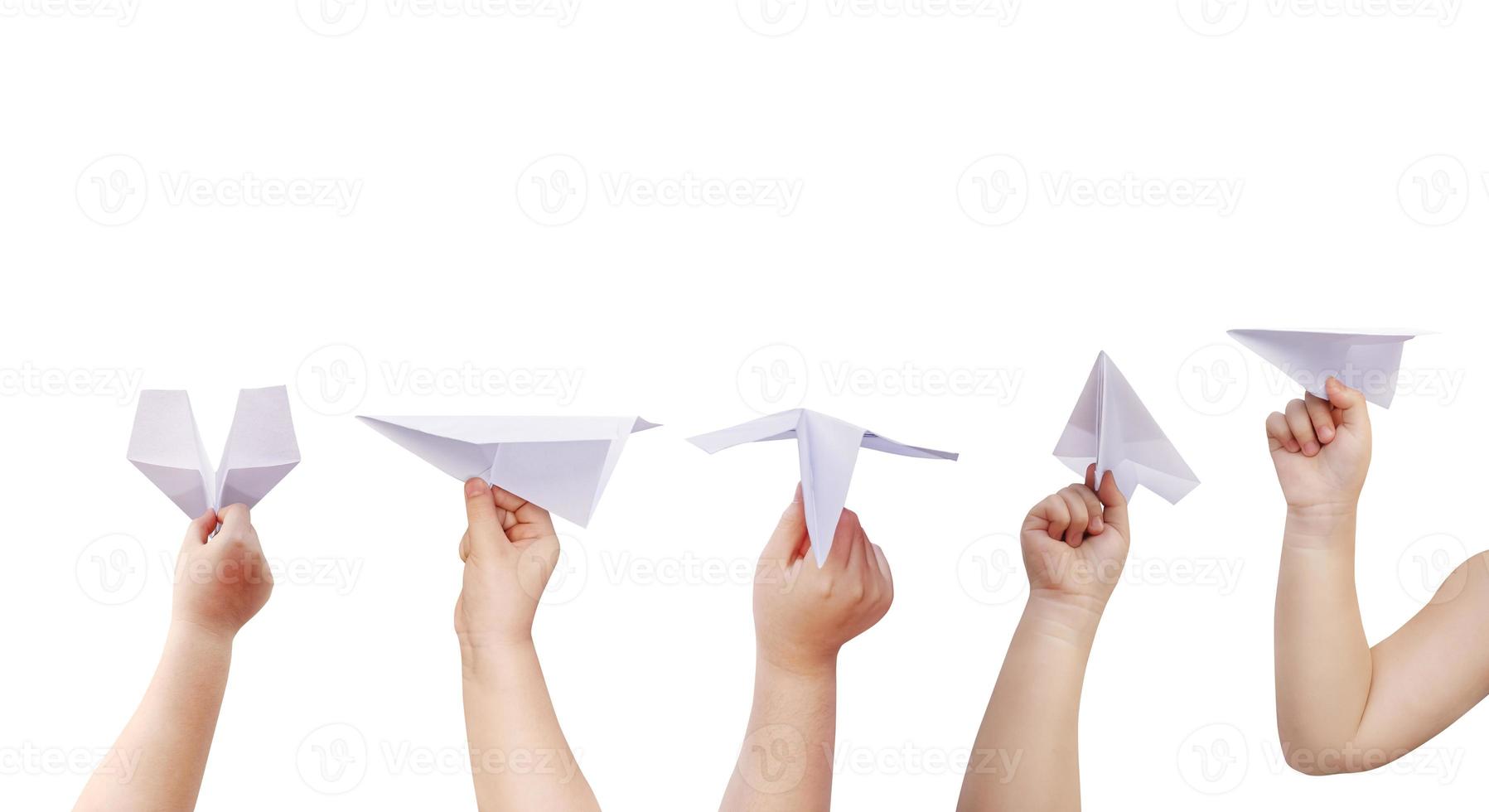 boy holding a paper plane isolated on white background photo