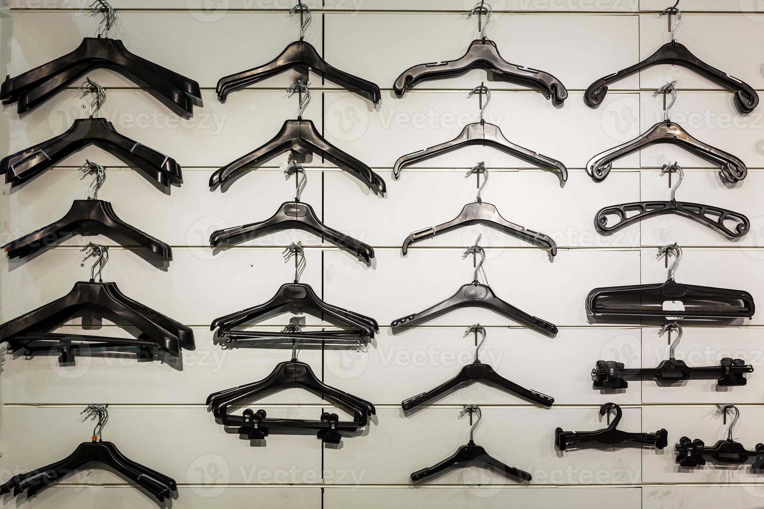 Set of coat hangers isolated on white background. Collection includes wooden, plastic, metallic