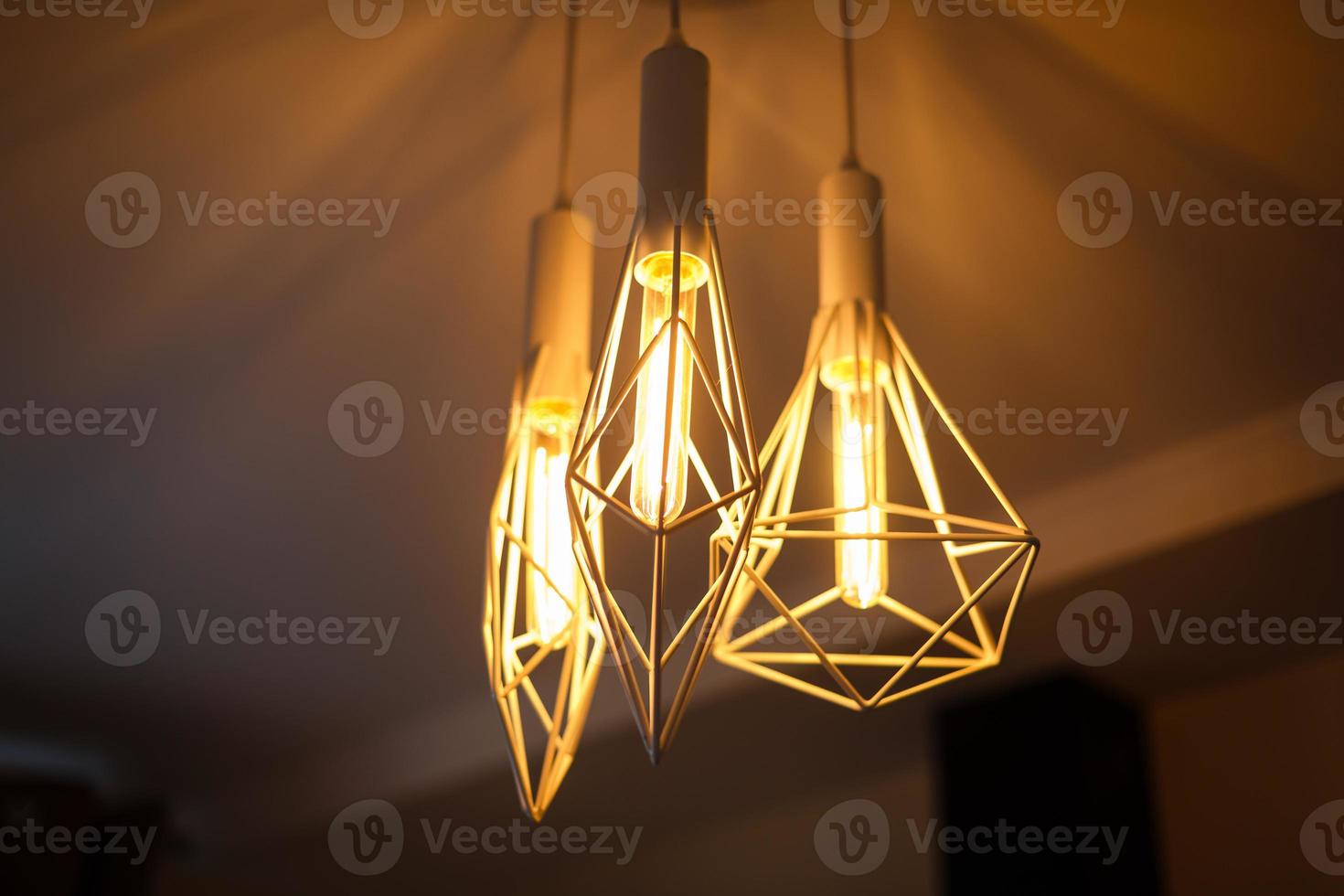 Industrial pendant lamps against rough wall loft interior edison bulbs photo