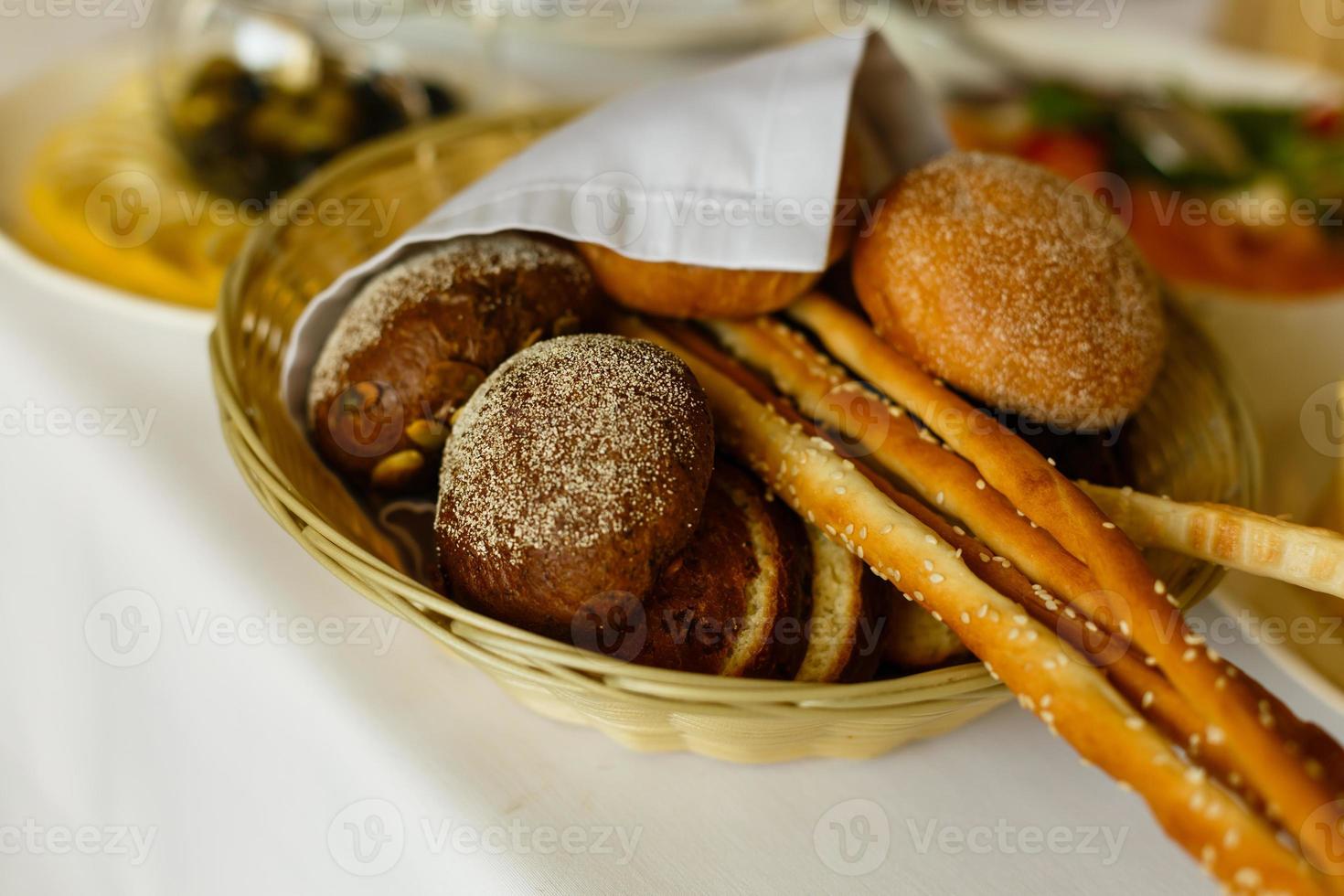 Breakfast with coffee and croissants in a basket on table photo