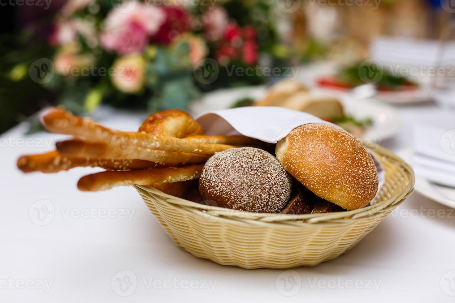 Bread in basket with butter under sunlight Buns bread in a basket table photo