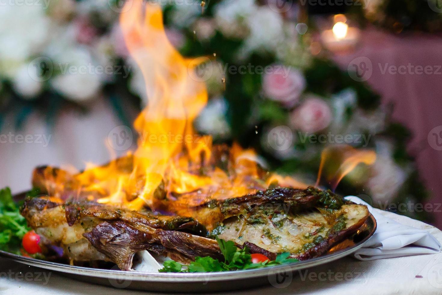 Burning jamon. Chef cooking pork ham photo