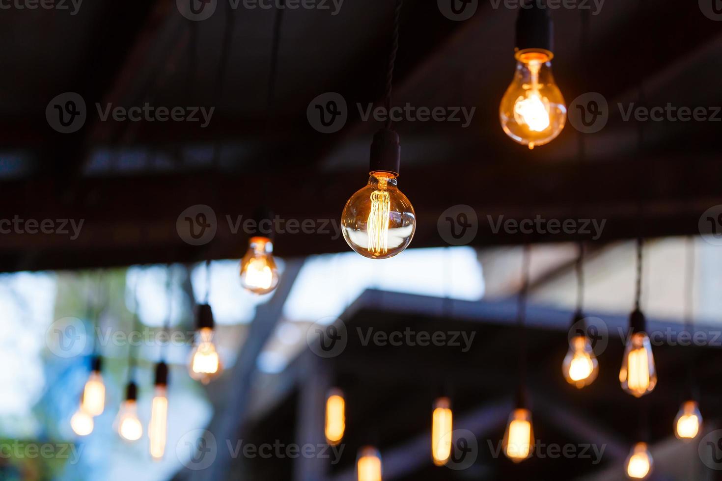 Luxury retro light bulb glowing Vintage style light bulbs hanging from the ceiling photo