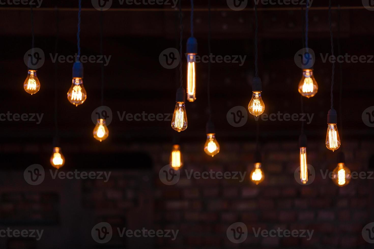 Luxury retro light bulb glowing Vintage style light bulbs hanging from the ceiling Many decorative light bulbs photo