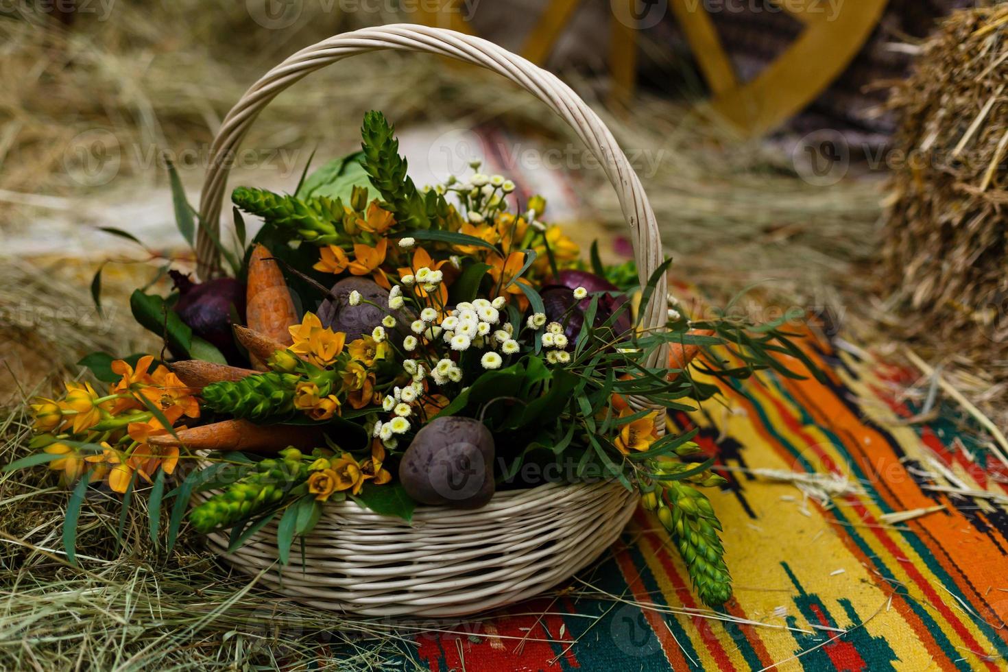 Basket with organic vegetables on the green grass and flowers. Outdoors. freshly harvested vegetables. raw vegetables in wicker basket.basket with Vegetables and Flowers photo