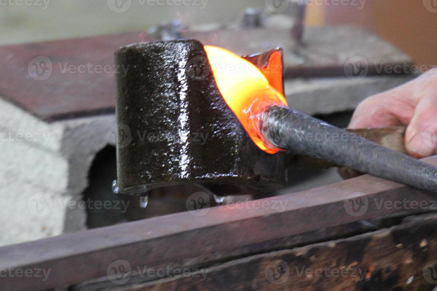 The master works with glass at a glass factory. photo