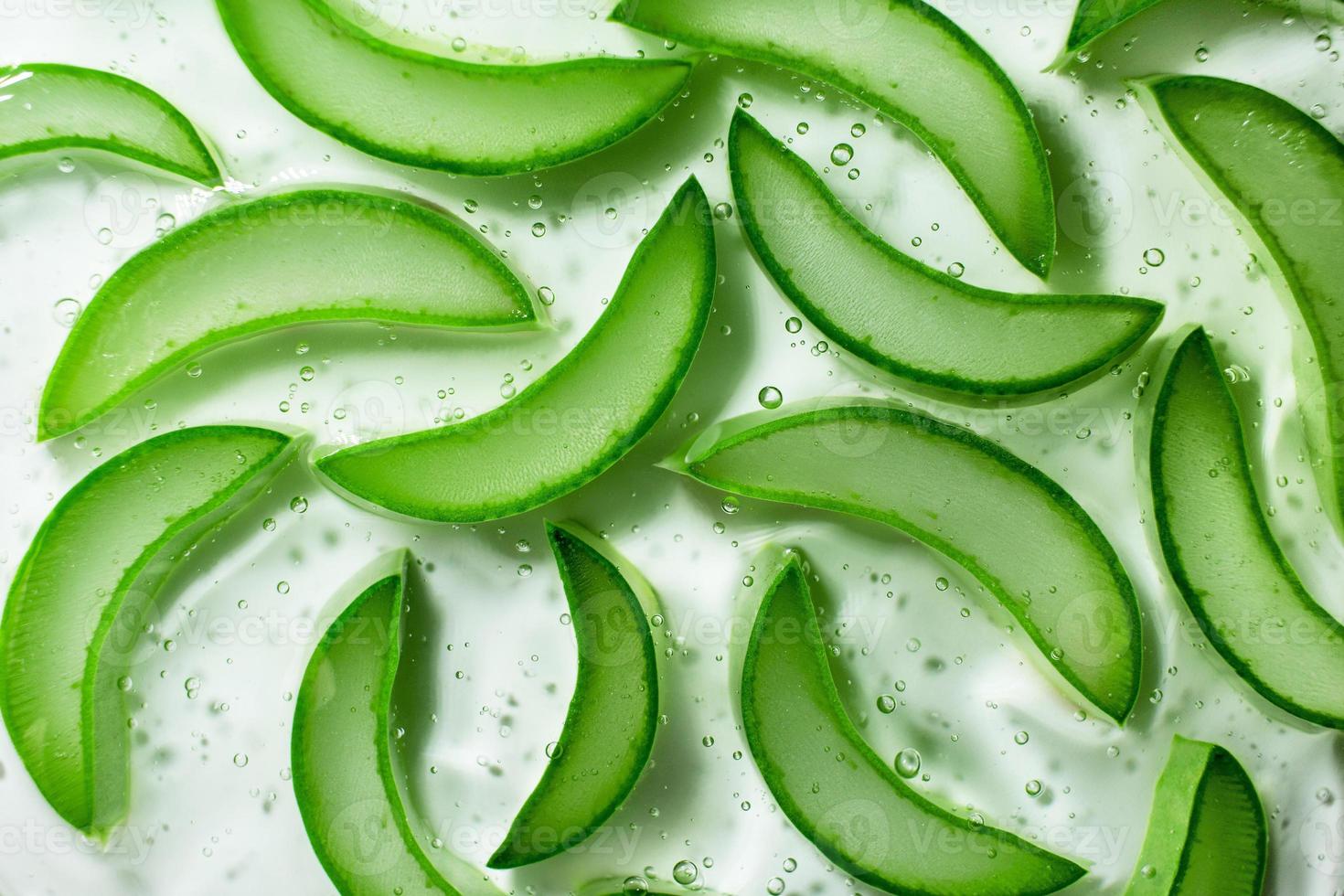 Gel with sliced slices of juicy aloe vera. Facial serum, skin care. Top view, copy space photo