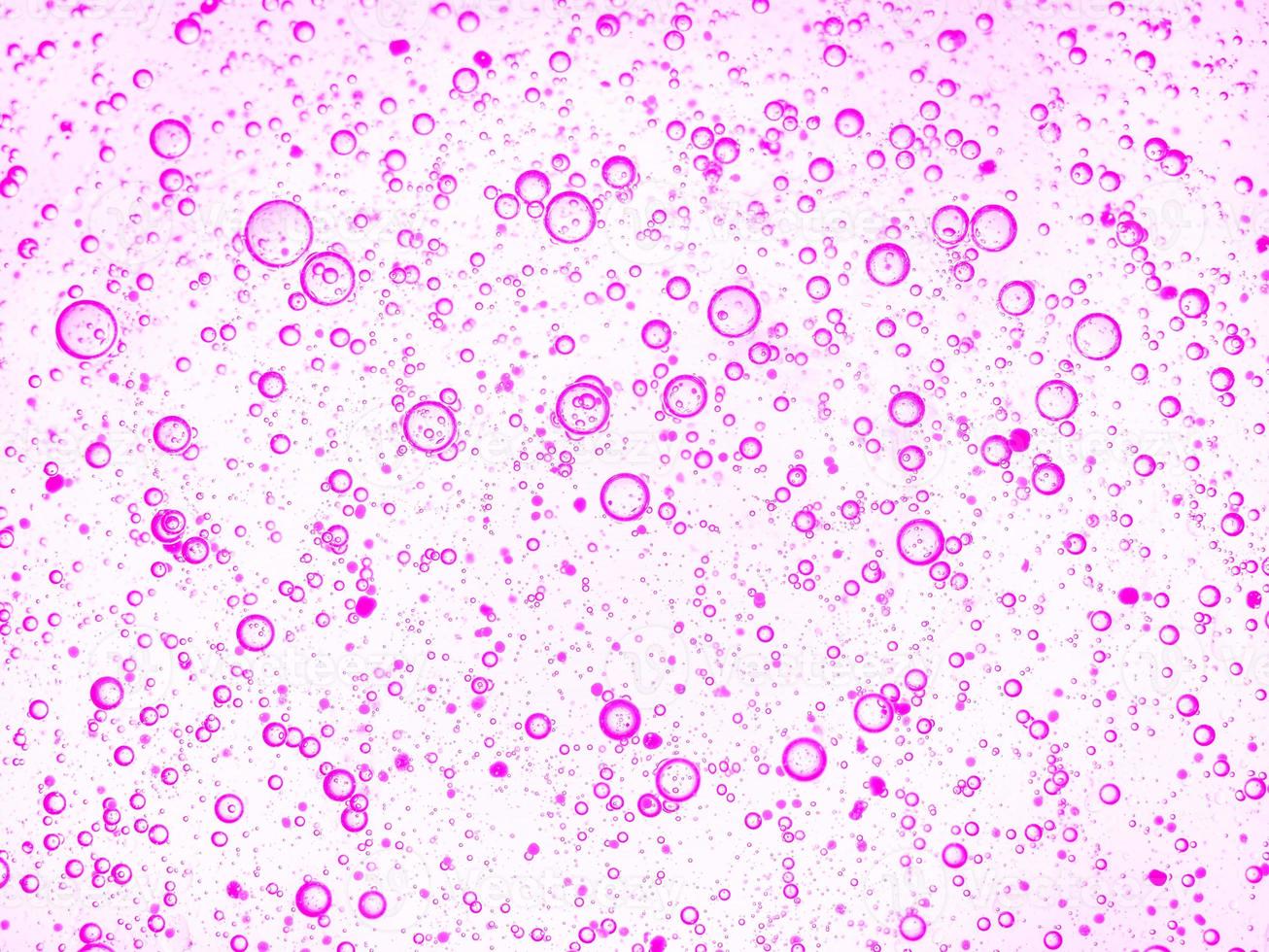 Gel with hyaluronic acid. Pink background with oxygen bubbles Cosmetic cream with oxygen bubbles photo
