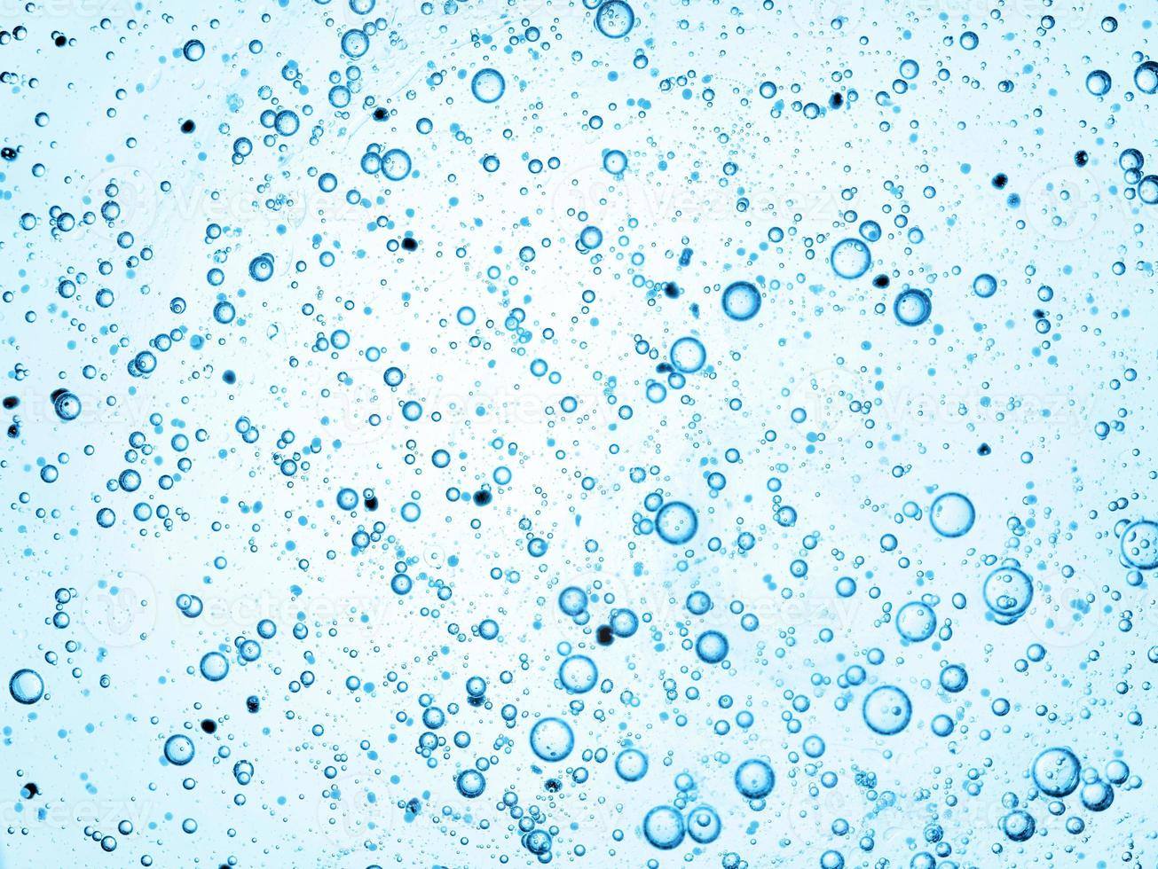 Gel with hyaluronic acid. Blue background with oxygen bubbles Cosmetic cream with oxygen bubbles photo