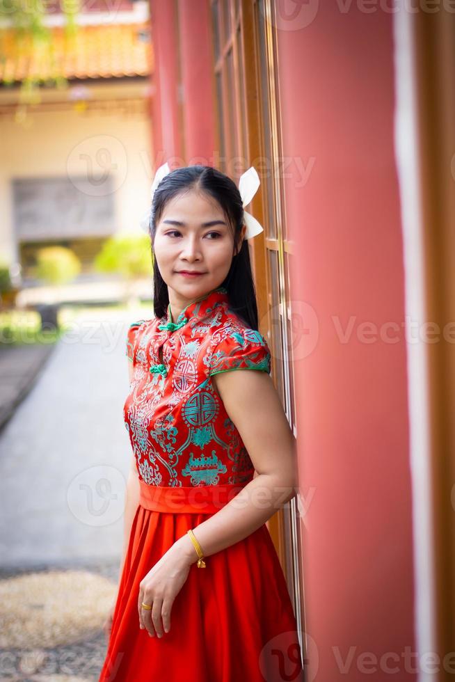 Smart girl in red  color dress style chiness new year in culture and public chiness temple background photo