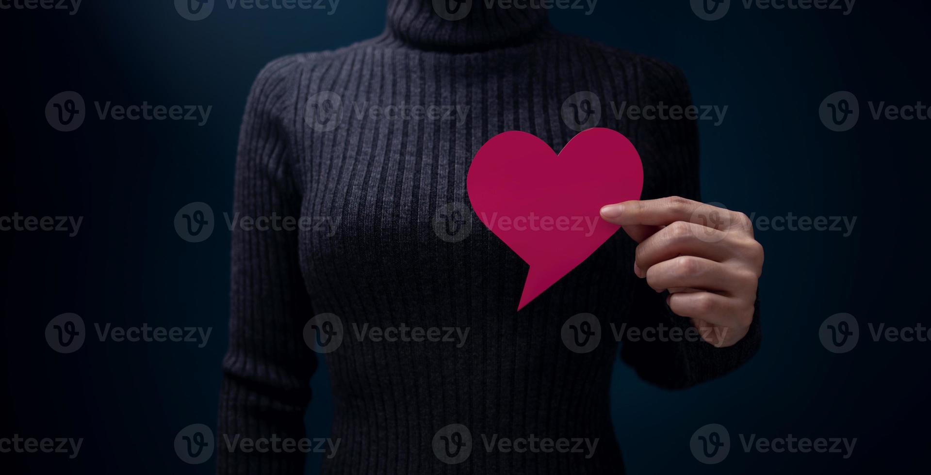 Speak Your Mind, Empowering and Female Voices, Saying from Heart Concepts. Woman Holding a Blank Bubble Speech Paper as Heart on Chest photo