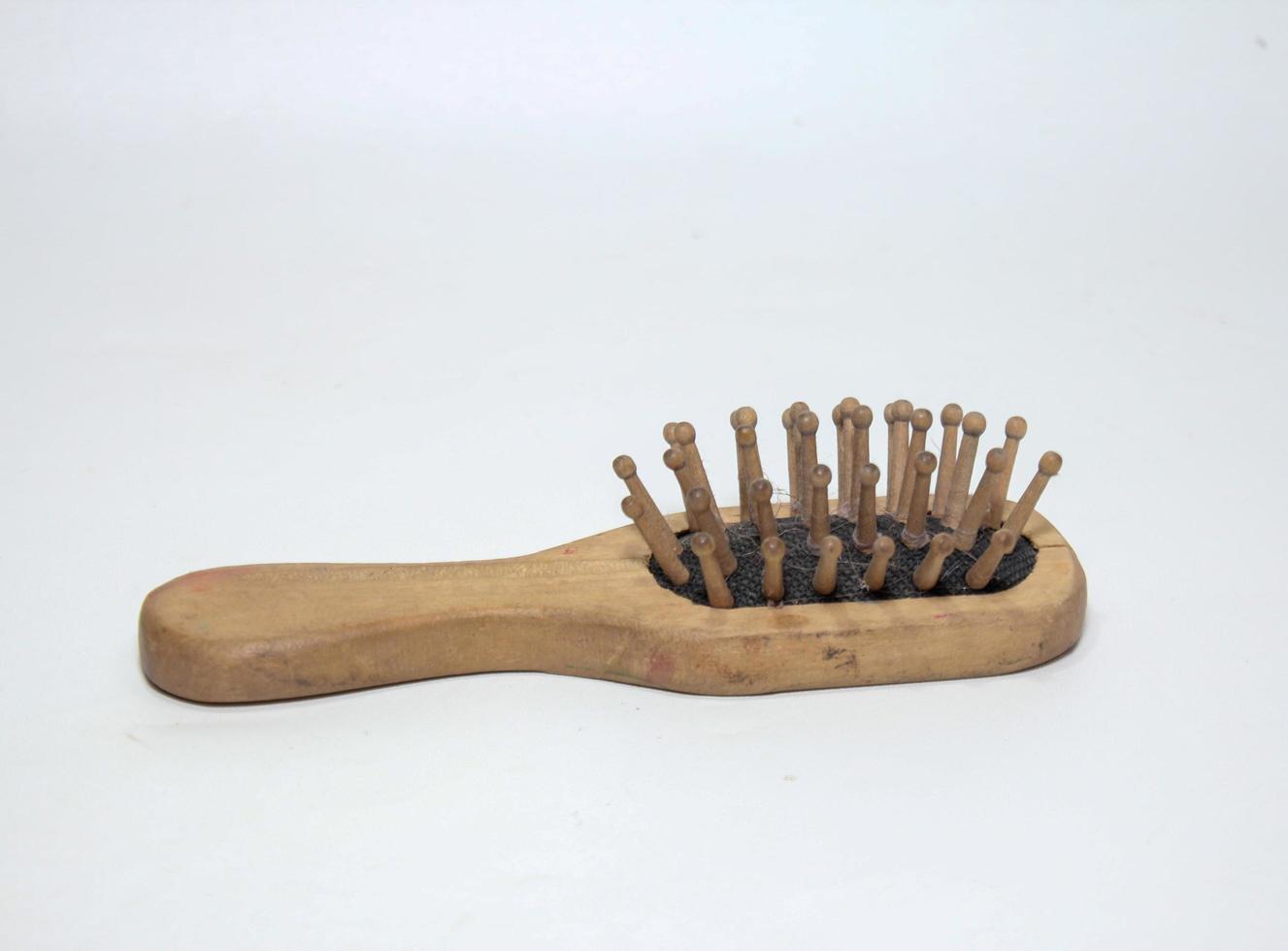 Used wooden comb on a white background photo
