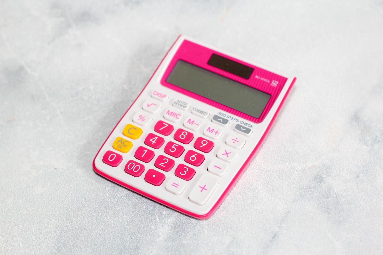 Pink calculator on white background for business financial concept photo