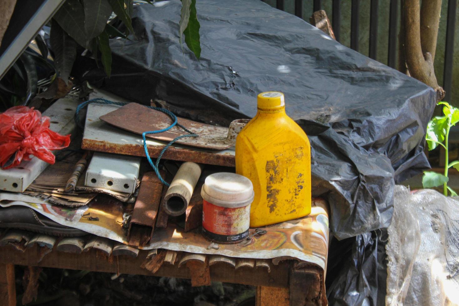 Plastic bottles of car oil in the trash photo