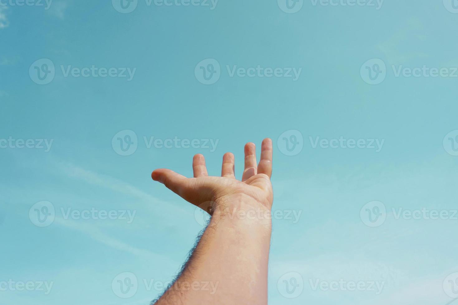 hand up in the air, gesturing in the sky feeling free photo