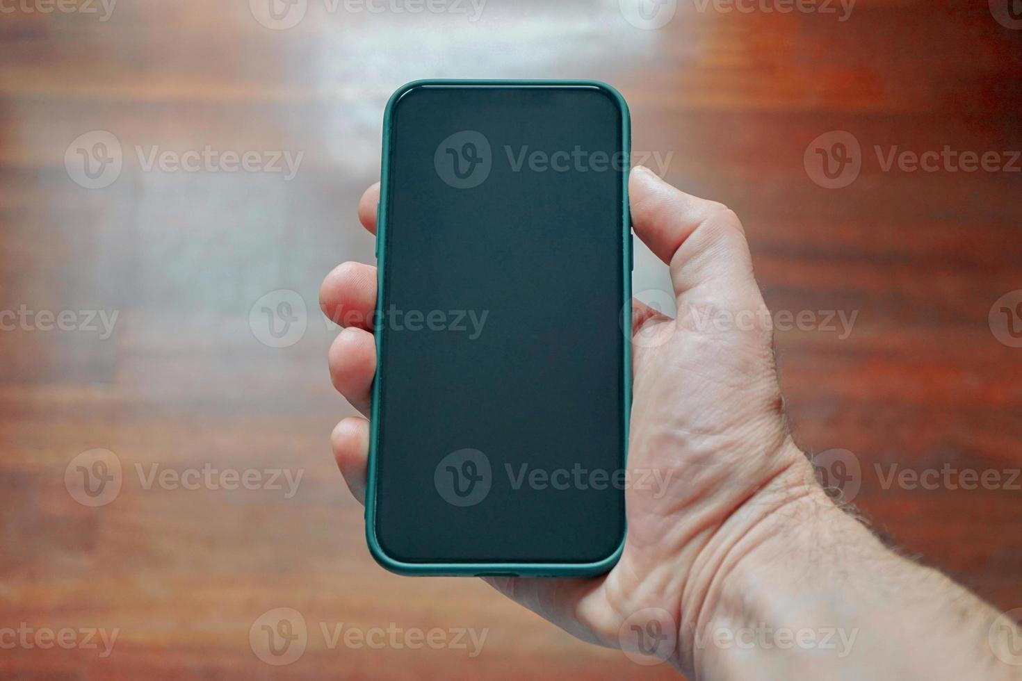 hand holding a smart phone, phone addicted photo