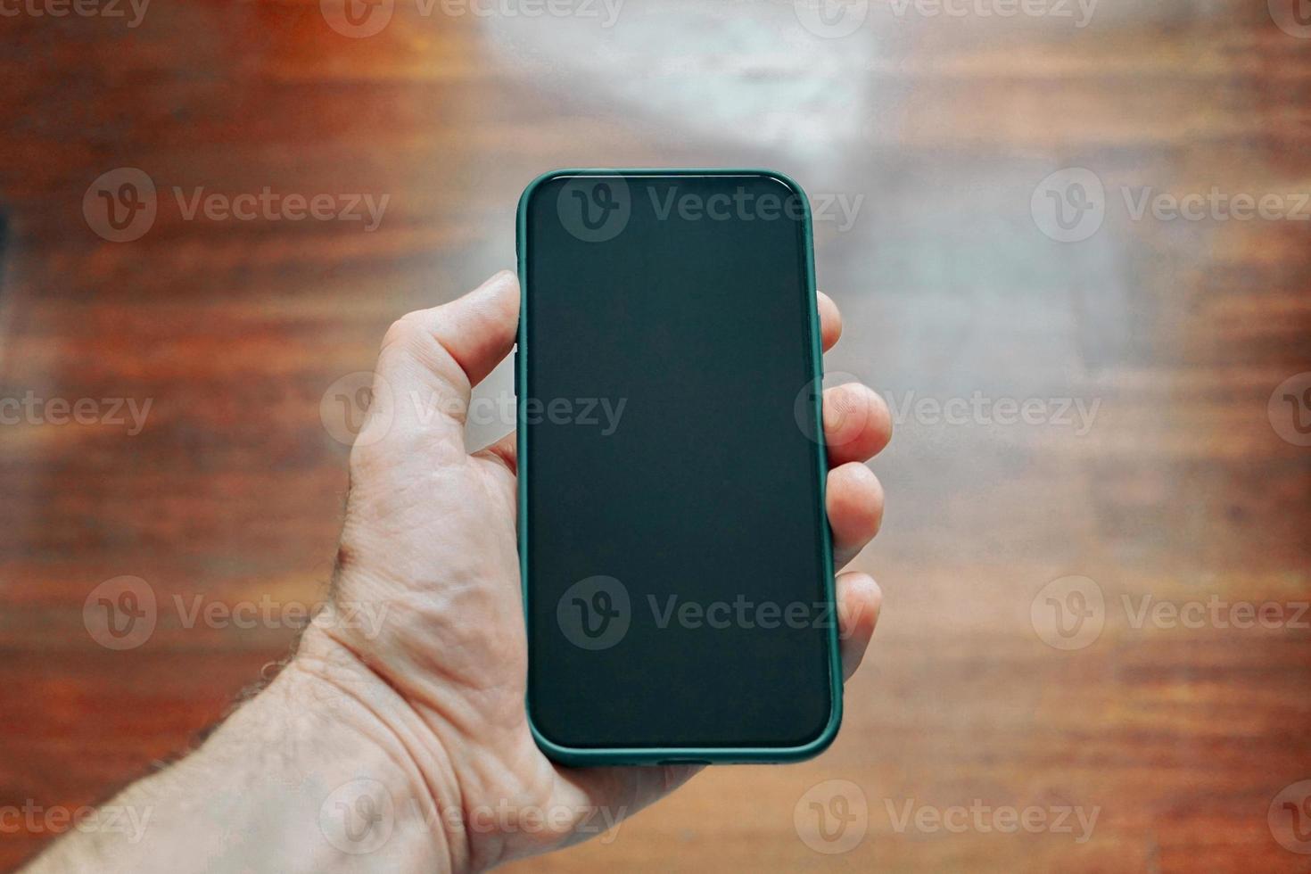hand holding a smart phone, phone addicted photo